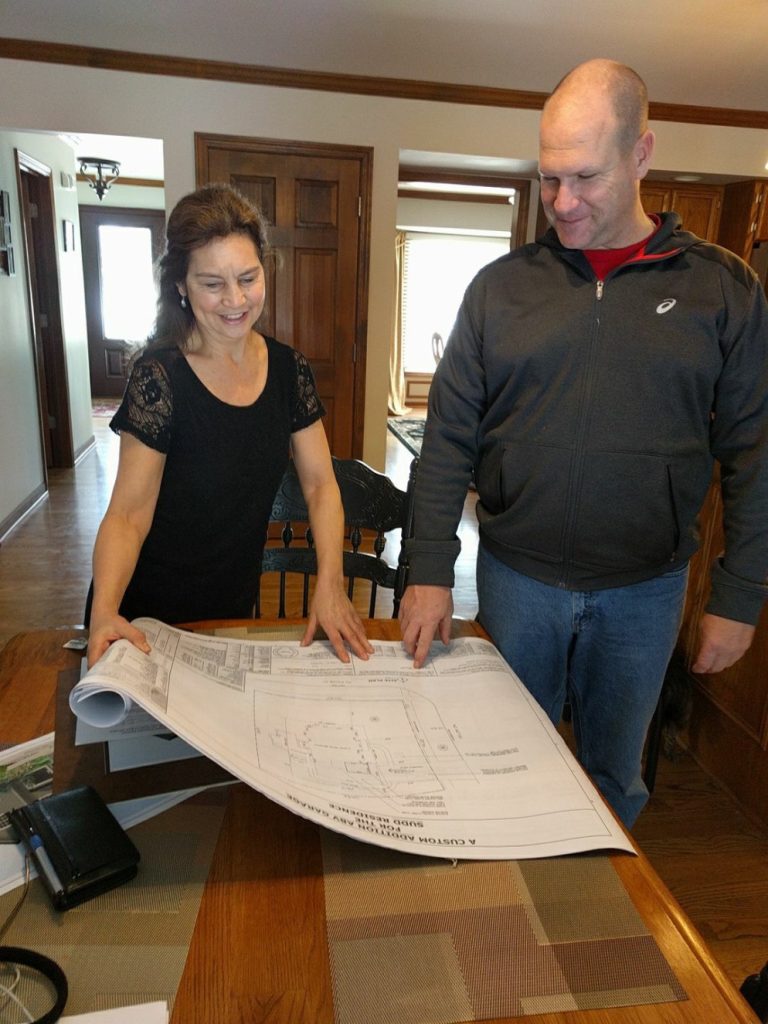 Julie Berkowicz reviewing community plans with a resident